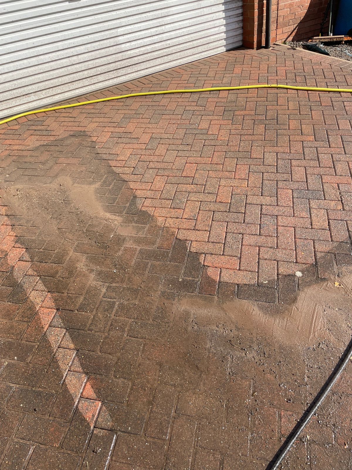 Block paving mid pressure wash showing the clean and dirty contrast