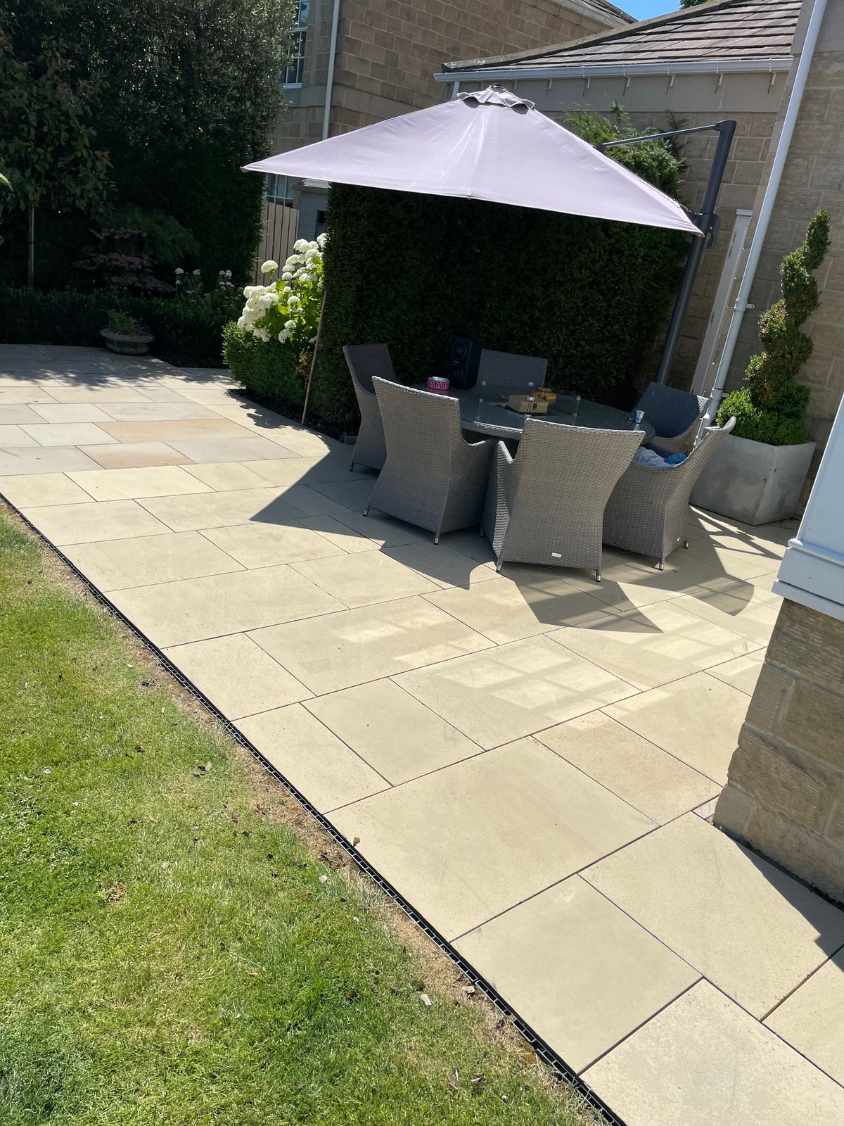 Clean paved patio with garden furniture