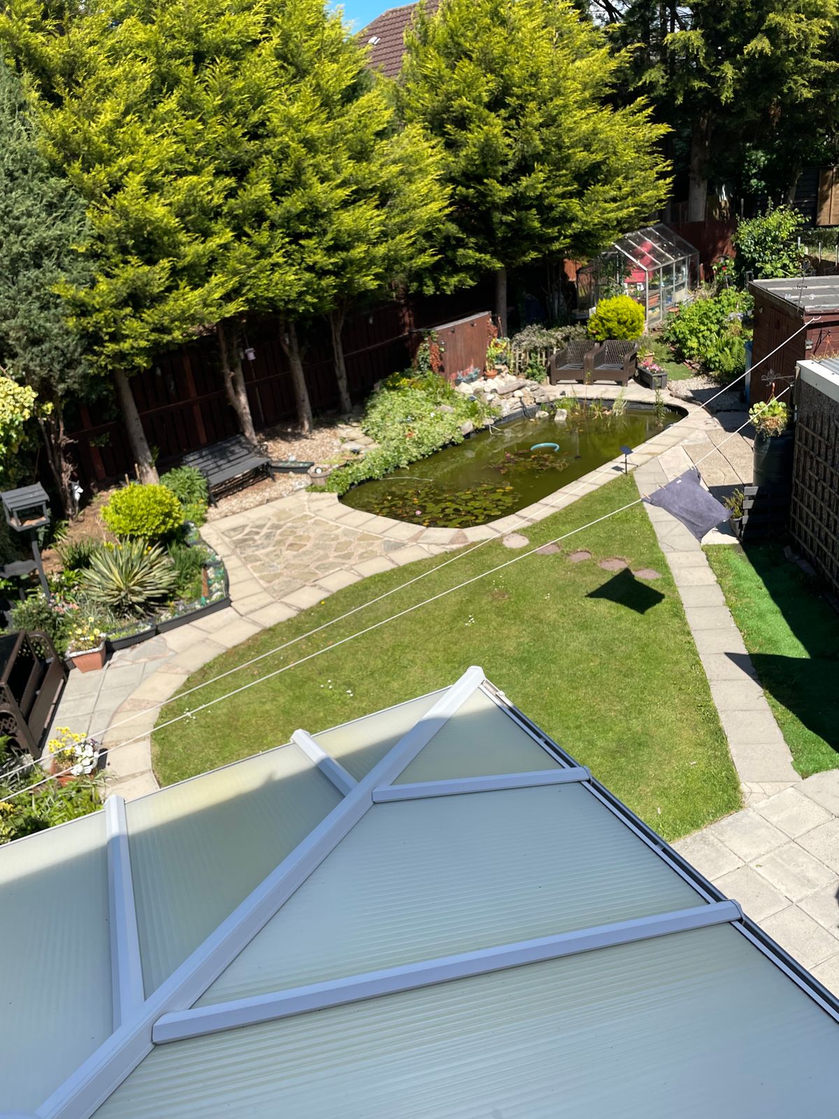 Clean patio overlooking a garden and pond